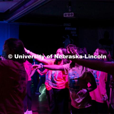 Students dancing in a "Rave"-like setting with glow lights and beach balls bouncing through the crowd. University of Nebraska–Lincoln students exceeded their goal, raising over $230,000 during the annual HuskerThon on Feb. 26. Also known as Dance Marathon, the event is part of a nationwide fundraiser supporting Children’s Miracle Network Hospitals. The annual event, which launched in 2006, is the largest student philanthropic event on campus. The mission of the event encourages participants to, “dance for those who can’t.” All funds collected by the Huskers benefit the Children’s Hospital and Medical Center in Omaha. February 26, 2022. Photo by Jonah Tran / University Communication.