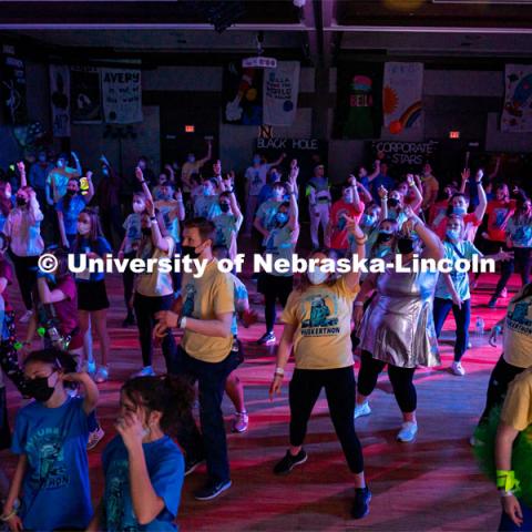 Students dancing in a "Rave"-like setting with glow lights and beach balls bouncing through the crowd. University of Nebraska–Lincoln students exceeded their goal, raising over $230,000 during the annual HuskerThon on Feb. 26. Also known as Dance Marathon, the event is part of a nationwide fundraiser supporting Children’s Miracle Network Hospitals. The annual event, which launched in 2006, is the largest student philanthropic event on campus. The mission of the event encourages participants to, “dance for those who can’t.” All funds collected by the Huskers benefit the Children’s Hospital and Medical Center in Omaha. February 26, 2022. Photo by Jonah Tran / University Communication.