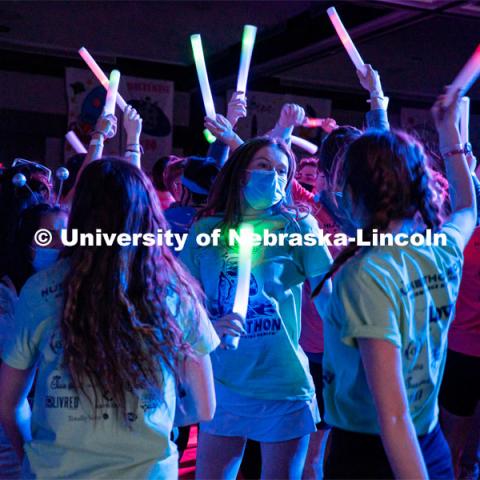 Students dancing in a "Rave"-like setting with glow lights and beach balls bouncing through the crowd. University of Nebraska–Lincoln students exceeded their goal, raising over $230,000 during the annual HuskerThon on Feb. 26. Also known as Dance Marathon, the event is part of a nationwide fundraiser supporting Children’s Miracle Network Hospitals. The annual event, which launched in 2006, is the largest student philanthropic event on campus. The mission of the event encourages participants to, “dance for those who can’t.” All funds collected by the Huskers benefit the Children’s Hospital and Medical Center in Omaha. February 26, 2022. Photo by Jonah Tran / University Communication.