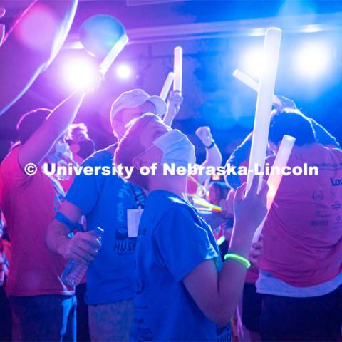 Students dancing in a "Rave"-like setting with glow lights and beach balls bouncing through the crowd. University of Nebraska–Lincoln students exceeded their goal, raising over $230,000 during the annual HuskerThon on Feb. 26. Also known as Dance Marathon, the event is part of a nationwide fundraiser supporting Children’s Miracle Network Hospitals. The annual event, which launched in 2006, is the largest student philanthropic event on campus. The mission of the event encourages participants to, “dance for those who can’t.” All funds collected by the Huskers benefit the Children’s Hospital and Medical Center in Omaha. February 26, 2022. Photo by Jonah Tran / University Communication.