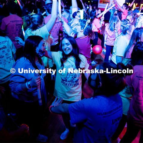 Students dancing in a "Rave"-like setting with glow lights and beach balls bouncing through the crowd. University of Nebraska–Lincoln students exceeded their goal, raising over $230,000 during the annual HuskerThon on Feb. 26. Also known as Dance Marathon, the event is part of a nationwide fundraiser supporting Children’s Miracle Network Hospitals. The annual event, which launched in 2006, is the largest student philanthropic event on campus. The mission of the event encourages participants to, “dance for those who can’t.” All funds collected by the Huskers benefit the Children’s Hospital and Medical Center in Omaha. February 26, 2022. Photo by Jonah Tran / University Communication.