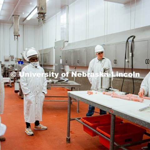 Leila Venzor demonstrates the sausage-making process. UNL Meat Science club had a Sausage Making 101 course in the Animal Science Complex. February 28, 2022. Photo by Jonah Tran / University Communication.