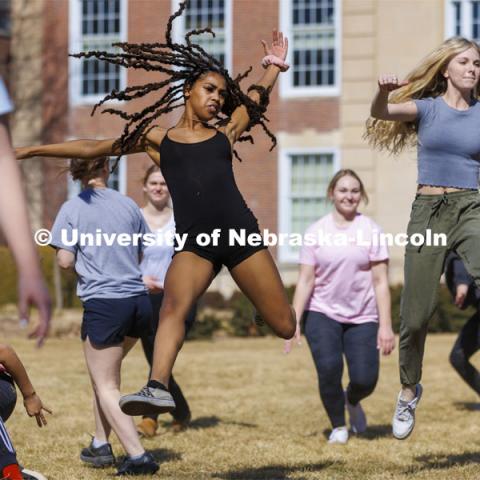 Susan Ourada’s Modern Dance 1 and 2 classes leap into the warm weather of the first day of March on the lawn outside Love Library. March 1, 2022. Photo by Craig Chandler / University Communication.