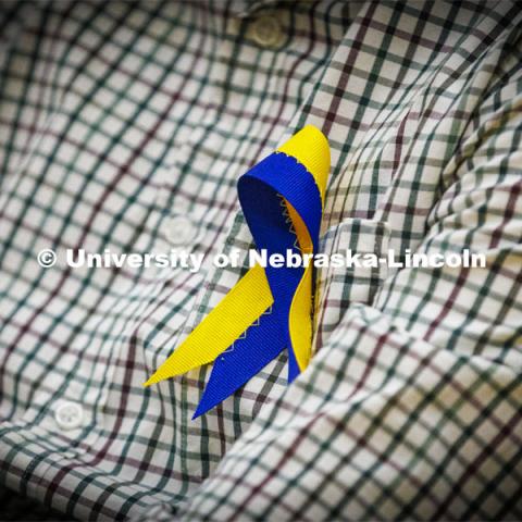 Members of the Ukrainian community in Lincoln wore blue and yellow ribbons to the event. Stand With Ukraine! panel discussion in the Nebraska Union ballroom Tuesday afternoon. March 1, 2022. Photo by Craig Chandler / University Communication.
