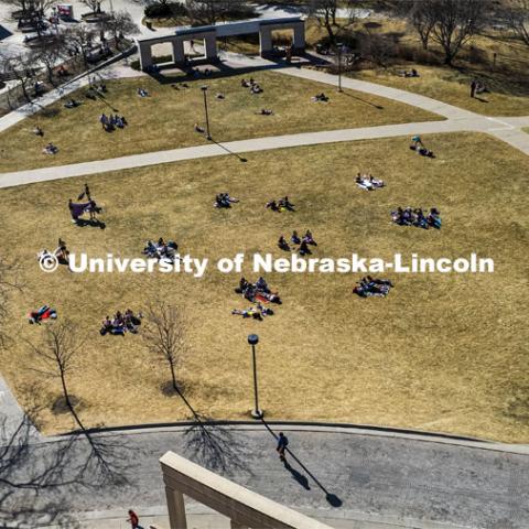 Aerial view of the City Campus green space filled with students laying out and soaking up some sun on the first warm days of March. March 2, 2022. Photo by Craig Chandler / University Communication.