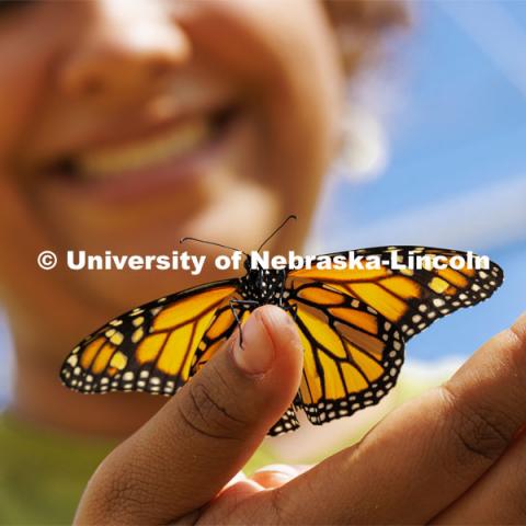 A Monarch butterfly rests on Miyauna Incarnato’s hand. Incarnato is a graduate student in Entomology studying Monarch butterflies. March 8, 2022. Photo by Craig Chandler / University Communication.