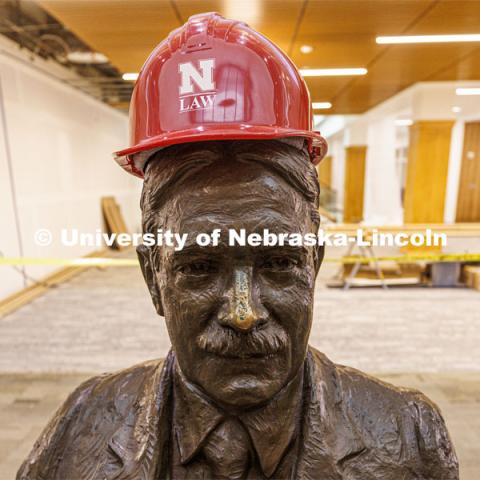Roscoe Pound wears a hard hat in the entry of the Law Library. Law college photo shoot. Nebraska Law Photo shoot. March 21, 2022. Photo by Craig Chandler / University Communication.