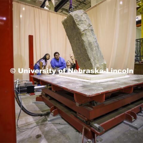 Christine Wittich talks with students as they position a slab on a large shake table in the structures lab. College of Engineering photo shoot. March 22, 2022. Photo by Craig Chandler / University Communication.