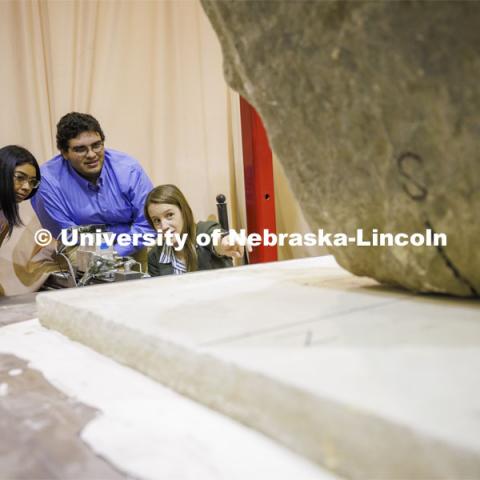 Christine Wittich talks with students as they position a slab on a large shake table in the structures lab. College of Engineering photo shoot. March 22, 2022. Photo by Craig Chandler / University Communication.