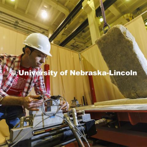 Mohammadreza Farooghi Mehr positions a slab on a large shake table in Christine Wittich’s structures lab in Scott Engineering Center. College of Engineering photo shoot. March 22, 2022. Photo by Craig Chandler / University Communication.