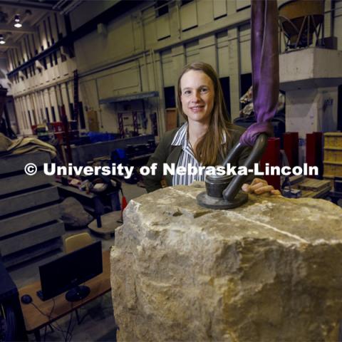 Christine Wittich, Assistant Professor of Civil and Environmental Engineering, with a slab on a large shake table in the structures lab. College of Engineering photo shoot. March 22, 2022. Photo by Craig Chandler / University Communication.