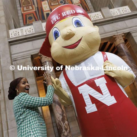ASUN President Batool Ibrahim high fives Lil’ Red. The day ended with participants mingling in the rotunda to meet with state senators and take photos with campus mascots. Fifth annual “I Love NU” advocacy event at the Nebraska State Capitol. March 23, 2022. Photo by Craig Chandler / University Communication.
