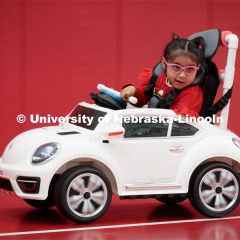 Four-year-old Dayana Torres enjoys the new, battery-powered car that UNL and UNMC students modified for her. Bowles was part of the team that modified the car for Torres.

Twice yearly, Nebraska’s Go Baby Go chapter modifies kid-sized battery powered cars for children with movement difficulties, providing them at no cost to the families. Nebraska’s GoBabyGo! chapter is funded by the Munroe-Meyer Guild. The program is a partnership between MMI's Department of Physical Therapy, the University of Nebraska-Lincoln and the University of Nebraska-Omaha Engineering Department and the UNMC College of Allied Health Professions/Physical Therapy students. The event took place on at the MMI building at 69th and Pine Streets in Omaha on Saturday, April 2, 2022. Photo by Kent Sievers / University of Nebraska Medicine.

