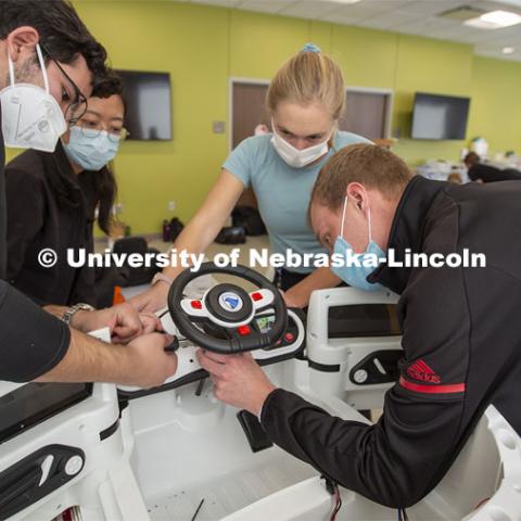Huskers Ricardo Gato Gil (left) and Chandler Brock (right) work as a team with Yuqi Pu (second from left) and Caroline Sauer (both from UNMC) to prepare a car during the GoBabyGo! event.

Twice yearly, Nebraska’s Go Baby Go chapter modifies kid-sized battery powered cars for children with movement difficulties, providing them at no cost to the families. Nebraska’s GoBabyGo! chapter is funded by the Munroe-Meyer Guild. The program is a partnership between MMI's Department of Physical Therapy, the University of Nebraska-Lincoln and the University of Nebraska-Omaha Engineering Department and the UNMC College of Allied Health Professions/Physical Therapy students. The event took place on at the MMI building at 69th and Pine Streets in Omaha on Saturday, April 2, 2022. Photo by Kent Sievers / University of Nebraska Medicine.

