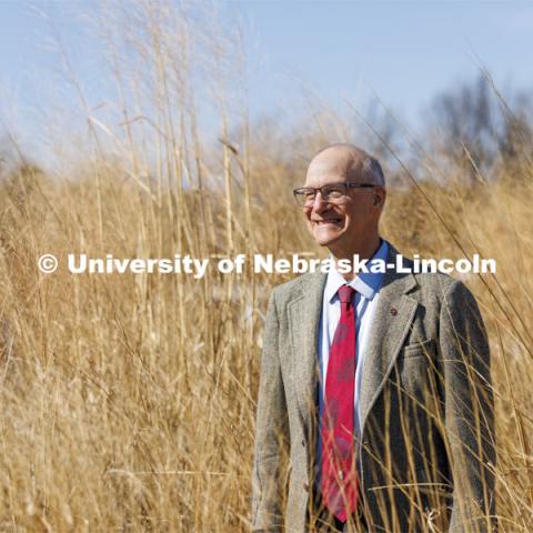 Robert Brooke, Professor of English,  is a 2022 OTICA winner His main teaching work has been in place-conscious education, so he was photographed in an outside space that might replicate Nebraska rurality. April 4, 2022. Photo by Craig Chandler / University Communication.