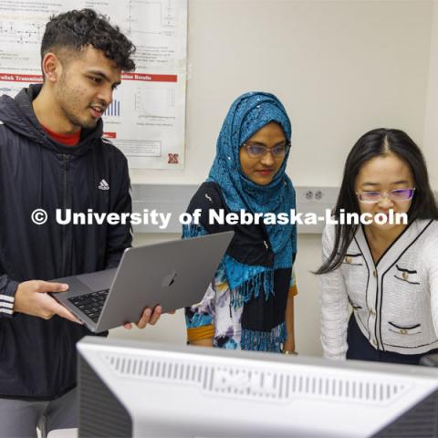 Chamath Gunawardena, Owana Manzia Moushi and Yili Jiang work on a Network and Security project. College of Engineering photo shoot at Peter Kiewit Institute in Omaha. April 5, 2022. Photo by Craig Chandler / University Communication.