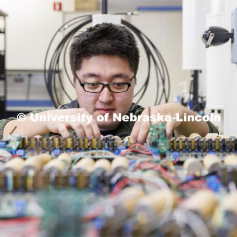 Zhenyu Meng works on a circuit board in Kuan Zhang’s IoT and AI lab. College of Engineering photo shoot at Peter Kiewit Institute in Omaha. April 5, 2022. Photo by Craig Chandler / University Communication.