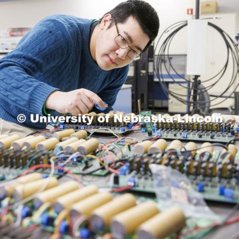 Shuaiqi Shen works on a circuit board in Kuan Zhang’s IoT and AI lab. College of Engineering photo shoot at Peter Kiewit Institute in Omaha. April 5, 2022. Photo by Craig Chandler / University Communication.