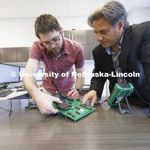 Matthew Boeding and Hamid Sherif test a board in Hamid Sherif’s Telecom lab. College of Engineering photo shoot at Peter Kiewit Institute in Omaha. April 5, 2022. Photo by Craig Chandler / University Communication.