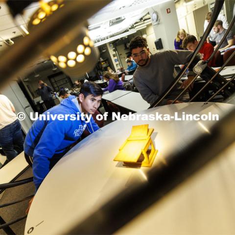 Students watch the changing shadows on a structure in a solar lighting setup in the lighting lab at PKI. College of Engineering photo shoot at Peter Kiewit Institute in Omaha. April 5, 2022. Photo by Craig Chandler / University Communication.