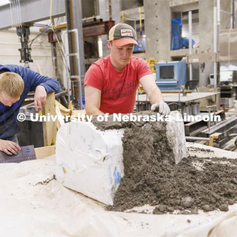 Braden Labenz, a junior from Columbus, Nebraska, works on a cross section as part of the concrete canoe race. The annual competition has engineers build a canoe from concrete that is raced against other universities. The cross section is to show the judges building techniques. College of Engineering photo shoot at Peter Kiewit Institute in Omaha. April 5, 2022. Photo by Craig Chandler / University Communication.