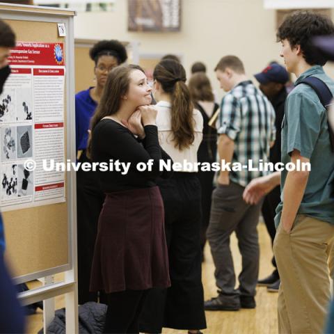 Maggie Ramsey listens to questions about her chemistry research project. Undergraduate Student Poster Session in the Nebraska Union ballroom as part of Student Research Days. April 11, 2022. Photo by Craig Chandler / University Communication.