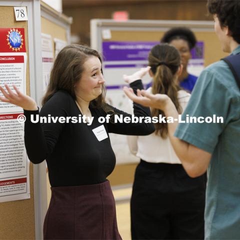 Maggie Ramsey debates her chemistry research project with a fellow student. Undergraduate Student Poster Session in the Nebraska Union ballroom as part of Student Research Days. April 11, 2022. Photo by Craig Chandler / University Communication.