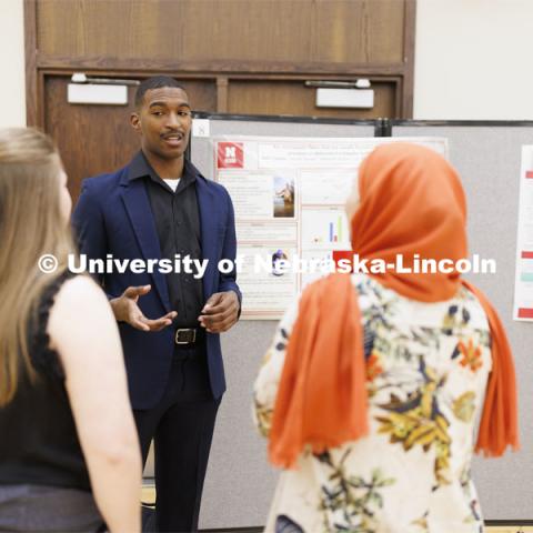 McNair Scholar Seth Caines discusses his summer research project researching textiles as a source of microplastic fibers to Nebraska streams. Undergraduate Student Poster Session in the Nebraska Union ballroom as part of Student Research Days. April 11, 2022. Photo by Craig Chandler / University Communication.