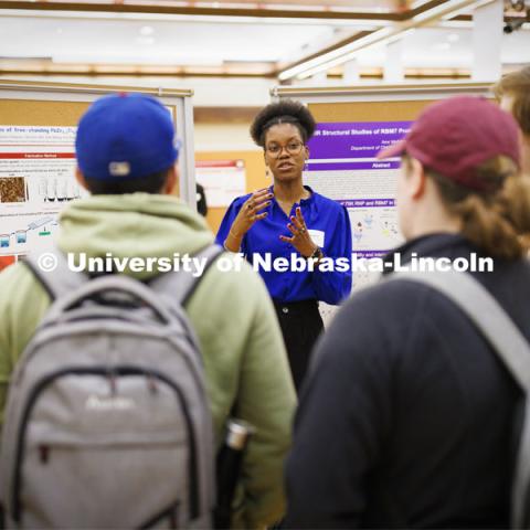 McNair Scholar Alyssa Simpson discusses her work researching ferroelectric domain studies in free-standing PbZr0.2Ti0.8O3 membranes. Undergraduate Student Poster Session in the Nebraska Union ballroom as part of Student Research Days. April 11, 2022. Photo by Craig Chandler / University Communication.