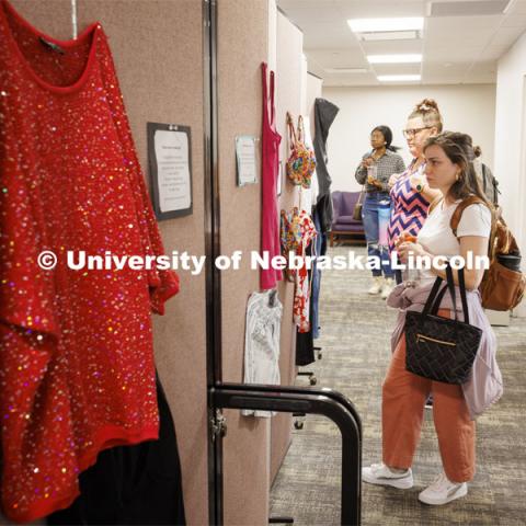 Graduate students Elyxcus Anaya and Jessica Boyles examine the “What Were You Wearing?” survivor art installation in the new CARE space within Neihardt. The display featured recreations of outfits worn by those who were sexually assaulted with accompanying stories from the survivors. It was shown in Neihardt Center as a way for Huskers to see the space CARE will move into during the summer. April 12, 2022. Photo by Craig Chandler / University Communication.