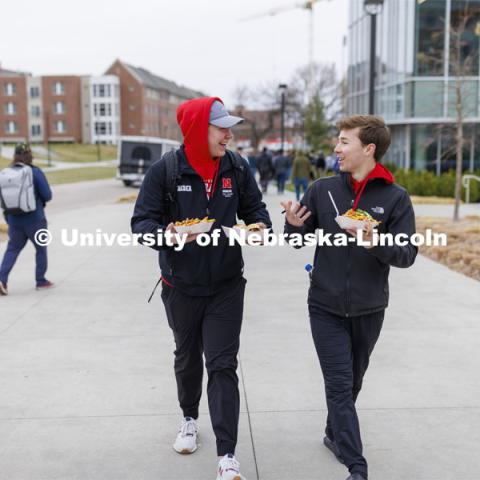 Will Bauer and Luke Skrabal, both freshman from Omaha, head back to their residence halls with food in hand from Motorfood. Students lined up for Food Trucks @ Lunch. Students could use their meal plan for a lunch outside the Cather Dining Center. Food provided by: 

• MARY ELLEN’S …Food for the soul.

• MOTORFOOD …Lincoln’s hardest rocking food truck!

• SAY CHEESE …Amazing grilled cheese sandwiches on fresh, homemade bread. April 19, 2022. Photo by Craig Chandler / University Communication.