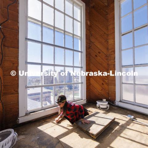 Erin Colonna, graphic designer with the University Libraries, documents signatures on the walls inside the Love Library cupola. The cupola will be renovated this summer following spring commencement. April 25, 2022. Photo by Craig Chandler / University Communication.