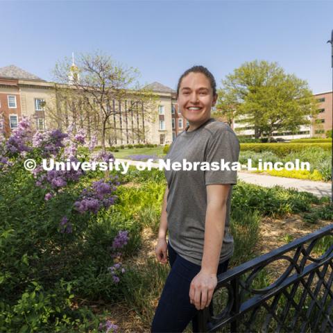 Taylor Daum, a junior English major for ASEM CoCreate story poses in the Love Gardens outside of Love Library. May 10, 2022. Photo by Craig Chandler / University Communication.