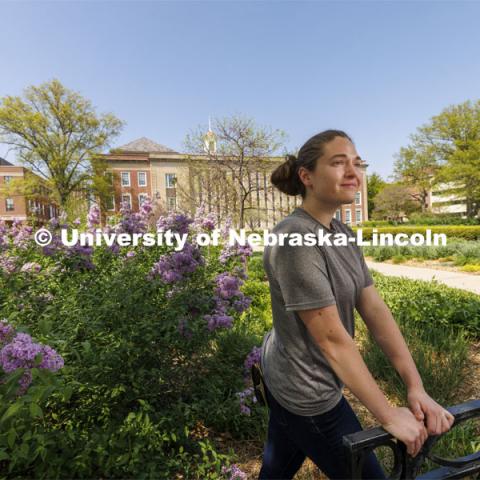 Taylor Daum, a junior English major for ASEM CoCreate story poses in the Love Gardens outside of Love Library. May 10, 2022. Photo by Craig Chandler / University Communication.