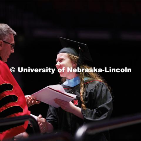 Chancellor Ronnie Green hands out diplomas to grads. Graduate commencement in Pinnacle Bank Arena. May 13, 2022. Photo by Craig Chandler / University Communication.