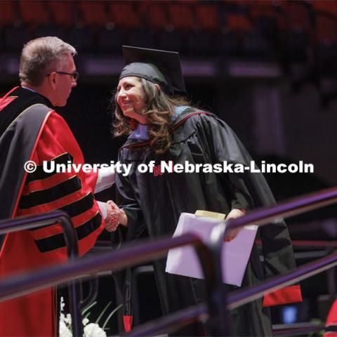 Chancellor Ronnie Green hands out diplomas to grads. Graduate commencement in Pinnacle Bank Arena. May 13, 2022. Photo by Craig Chandler / University Communication.