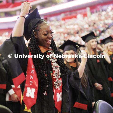 Mi’Cole Cayton moves her tassel during commencement. The Huskers women’s basketball player received her masters degree. The Husker athletes are wearing a custom stole during the commencements. Graduate commencement in Pinnacle Bank Arena. May 13, 2022. Photo by Craig Chandler / University Communication.