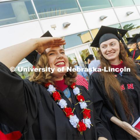 Anna Kuhlman looks for her family outside Pinnacle Bank Arena following commencement. Graduate commencement in Pinnacle Bank Arena. May 13, 2022. Photo by Craig Chandler / University Communication.