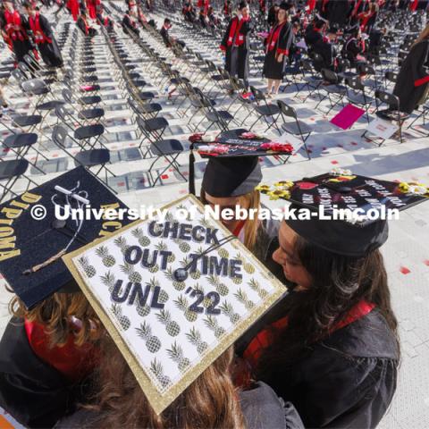 Decorated mortarboards at UNL undergraduate commencement in Memorial Stadium. May 14, 2022. Photo by Craig Chandler / University Communication.