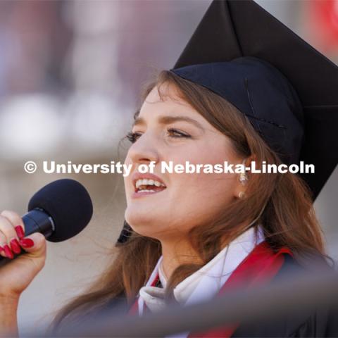 Rose Seeman sings the national anthem before the start of the UNL undergraduate commencement in Memorial Stadium. May 14, 2022. Photo by Craig Chandler / University Communication.