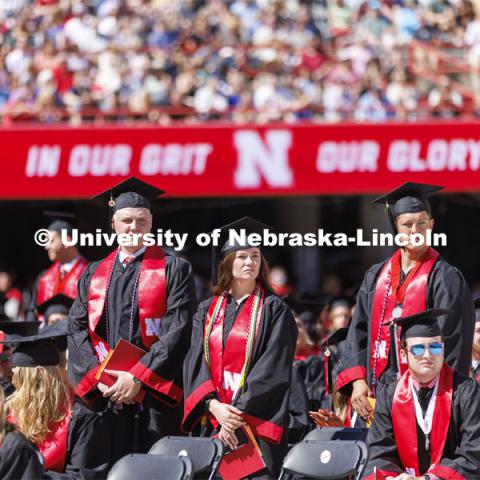 Graduates who have served in the military stand and are honored during the UNL undergraduate commencement in Memorial Stadium. May 14, 2022. Photo by Craig Chandler / University Communication.