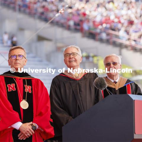 Terry Fairfield, center, along with UNL Chancellor Ronnie Green, left, and NU Regent Bob Phares watch a video about Fairfield’s accomplishments. Fairfield was honored with the Nebraska Builder Award. UNL undergraduate commencement in Memorial Stadium. May 14, 2022. Photo by Craig Chandler / University Communication.