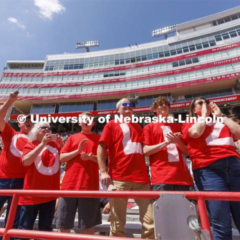 The family of Liz Endecott, a psychology major from Lee’s Summit, Missouri, cheer her as she receives her diploma. UNL undergraduate commencement in Memorial Stadium. May 14, 2022. Photo by Craig Chandler / University Communication.