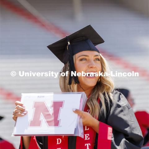Nicole Hansen, College of Business, graduate, smiles to her family and friends after receiving her diploma. UNL undergraduate commencement in Memorial Stadium. May 14, 2022. Photo by Craig Chandler / University Communication.