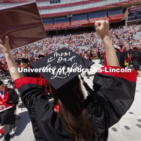 Skylar Hanson waves to her family as she returns to her seat with her diploma. UNL undergraduate commencement in Memorial Stadium. May 14, 2022. Photo by Craig Chandler / University Communication.