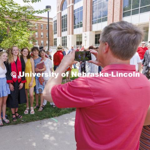 Morgan Heasty and family pose for photos following the UNL undergraduate commencement in Memorial Stadium. May 14, 2022. Photo by Craig Chandler / University Communication.