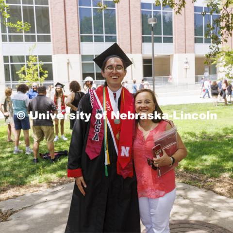 Antonio Linhart and family pose for photos following the UNL undergraduate commencement in Memorial Stadium. May 14, 2022. Photo by Craig Chandler / University Communication.