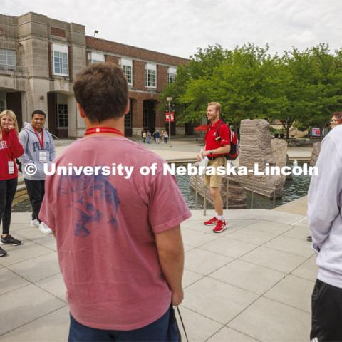 Jackson Anderson’s group of students talk before walking to Cather Dining Hall for lunch. New Student Enrollment, June 1, 2022. Photo by Craig Chandler / University Communication.