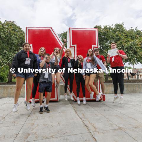 Jack Kinney’s NSE group leaps in front of the inflatable N sculpture on the Union Plaza after touring campus. New Student Enrollment. June 1, 2022. Photo by Craig Chandler / University Communication.