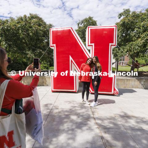 Fiona Cunningham and Ava Higman, both of Elmhurst, Illinois, pose for their parents in front of the inflatable N sculpture on the Union Plaza. New Student Enrollment. June 1, 2022. Photo by Craig Chandler / University Communication.